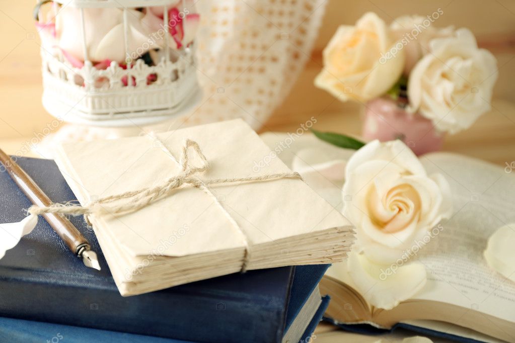 handwritten letters, fresh roses, old book