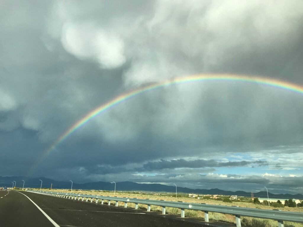 Rainbow across cloudy sky