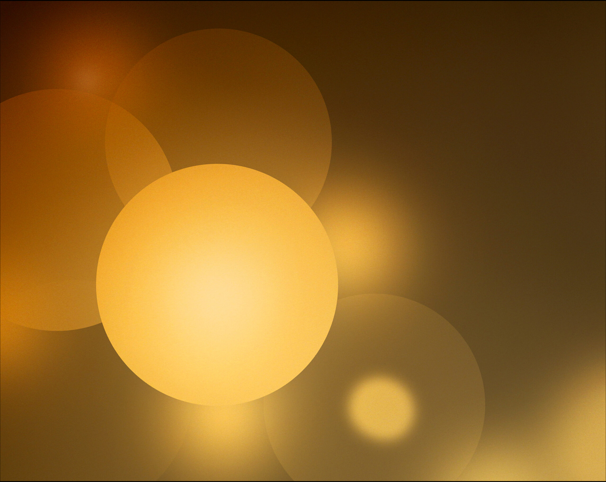 Photo of yellow orbs of various density. One has a focal point