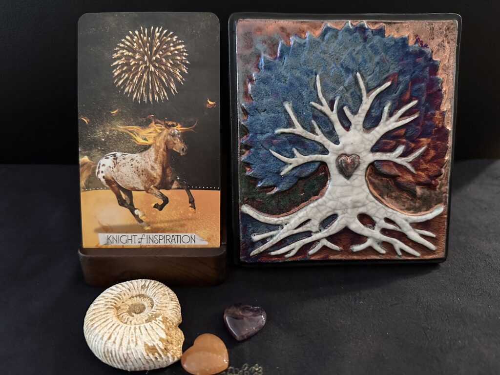 Knight of Inspiration card from Muse Tarot by Chris-Anne. Tree of Life plaque by J. Diller. Ammonite with sunstone and amethyst heart crystals.